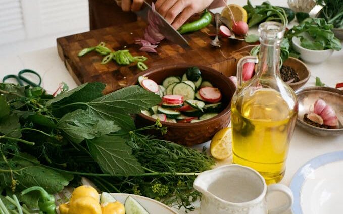 Person Slicing Vegetables on Chopping Board