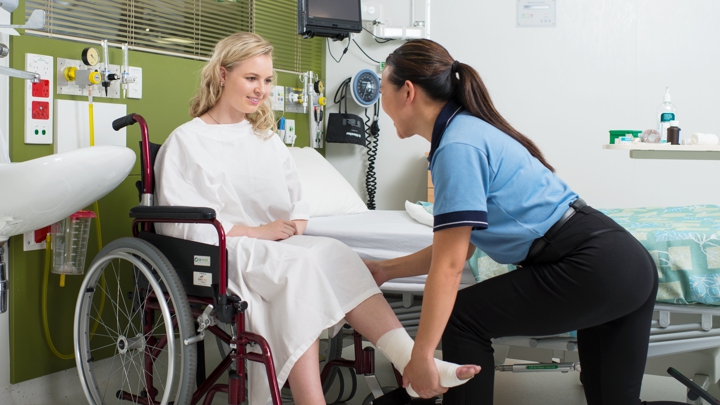 professional working with a client in a wheelchair