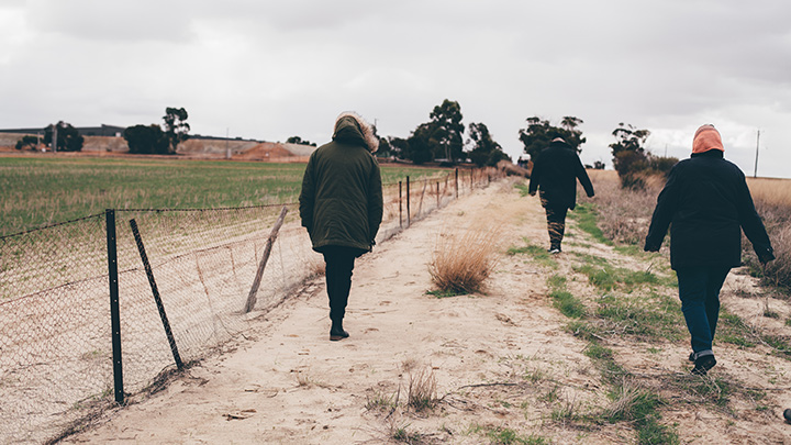 Staff walking along a path during an on country visit