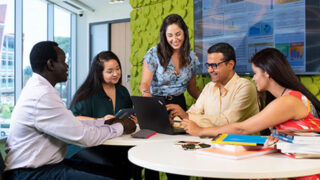 A group of students sitting around a table studying